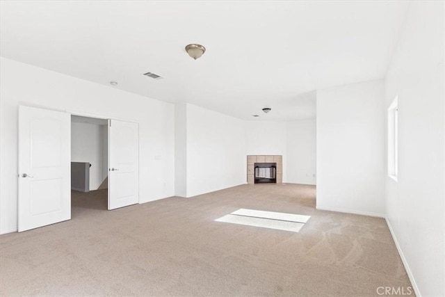 unfurnished living room featuring a fireplace and carpet flooring