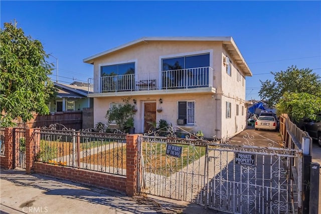 view of front of home featuring a balcony