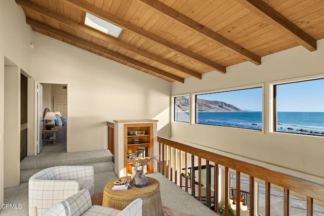 hallway featuring carpet, a skylight, a water view, wooden ceiling, and beam ceiling