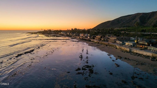 property view of water featuring a mountain view and a view of the beach