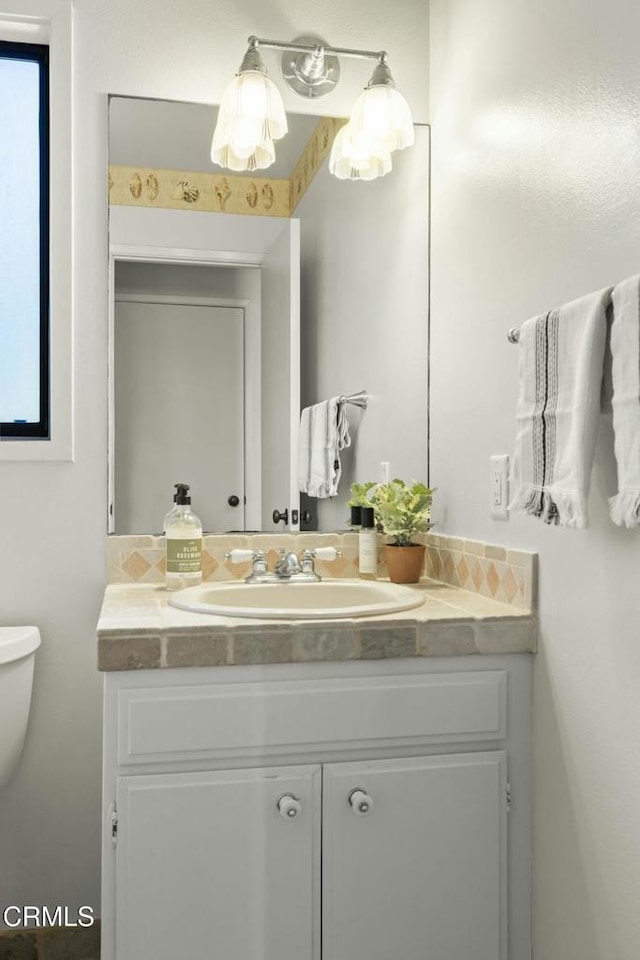 bathroom featuring toilet and vanity