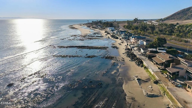 aerial view with a water view and a view of the beach