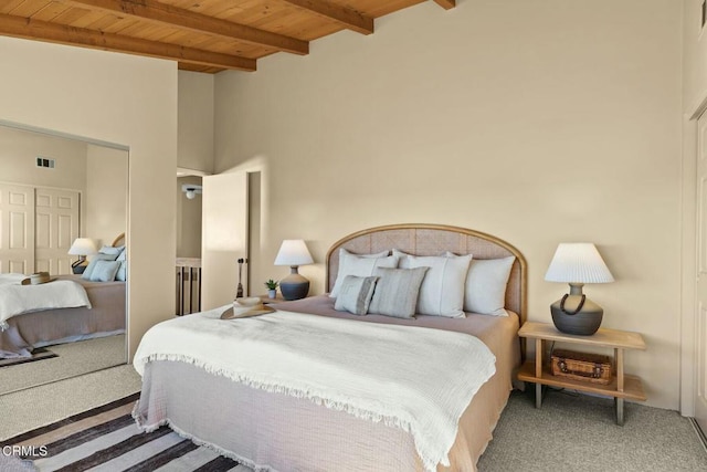 bedroom with wooden ceiling, beam ceiling, and carpet flooring