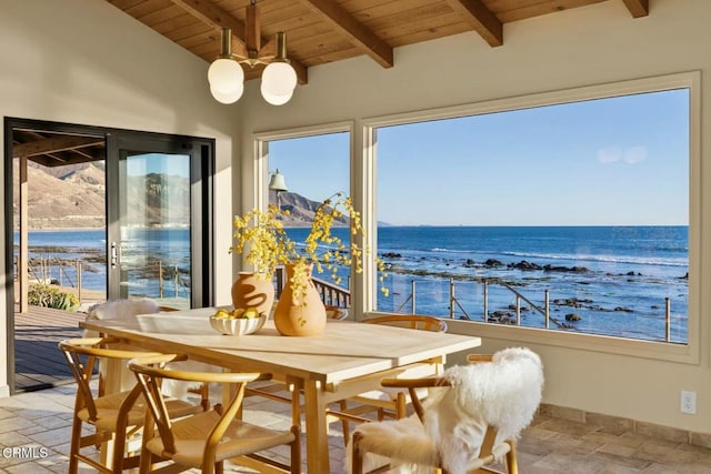 sunroom / solarium with lofted ceiling with beams, a healthy amount of sunlight, a water view, and wood ceiling