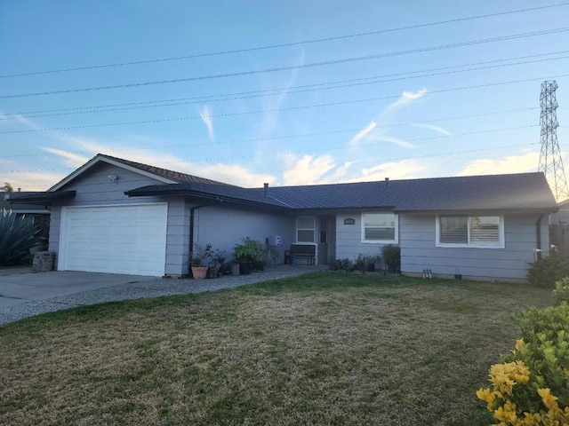 single story home with a garage and a front lawn