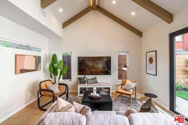 living room with hardwood / wood-style flooring, high vaulted ceiling, beamed ceiling, and a wealth of natural light