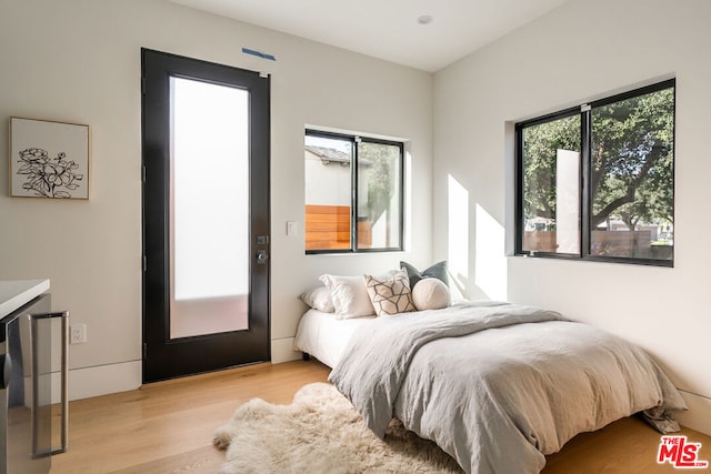 bedroom featuring light hardwood / wood-style floors and multiple windows