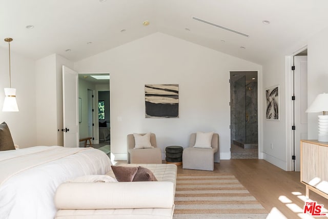 bedroom with light hardwood / wood-style floors and lofted ceiling