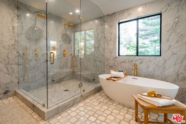 bathroom featuring shower with separate bathtub