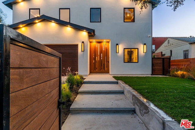 contemporary house featuring a garage and a yard