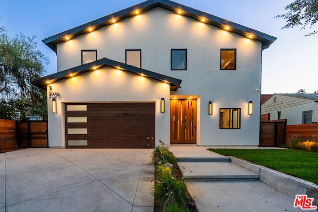 contemporary house with a lawn and a garage