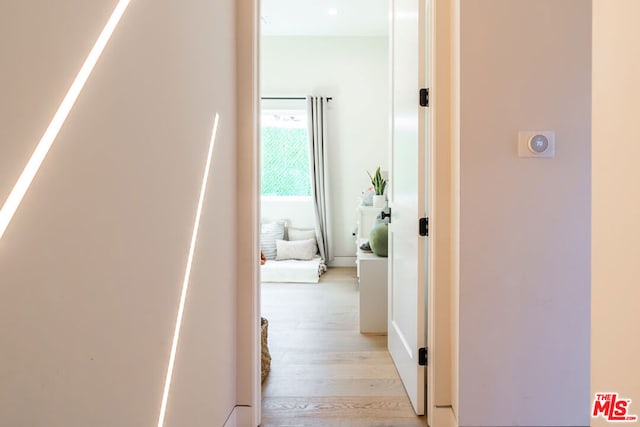 corridor with light hardwood / wood-style flooring