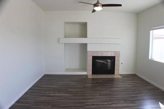 unfurnished living room featuring ceiling fan, dark hardwood / wood-style floors, and a fireplace