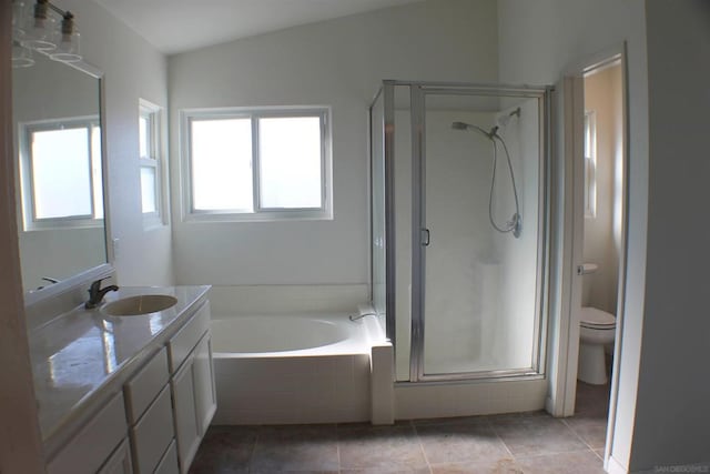 full bathroom featuring independent shower and bath, toilet, tile patterned floors, vanity, and vaulted ceiling