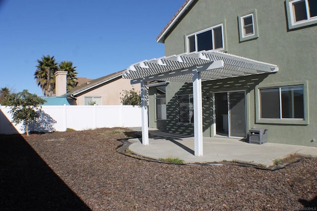 back of property featuring a patio and a pergola