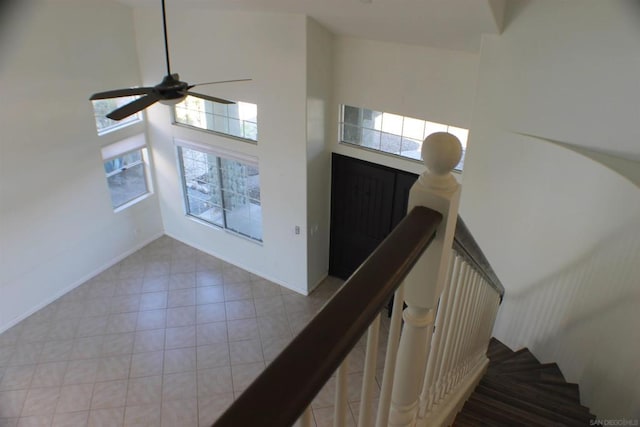 stairs with a high ceiling and ceiling fan