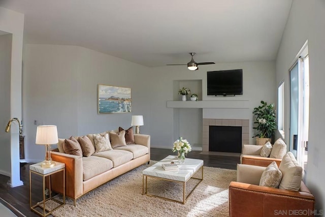 living room featuring a fireplace, hardwood / wood-style floors, lofted ceiling, and ceiling fan