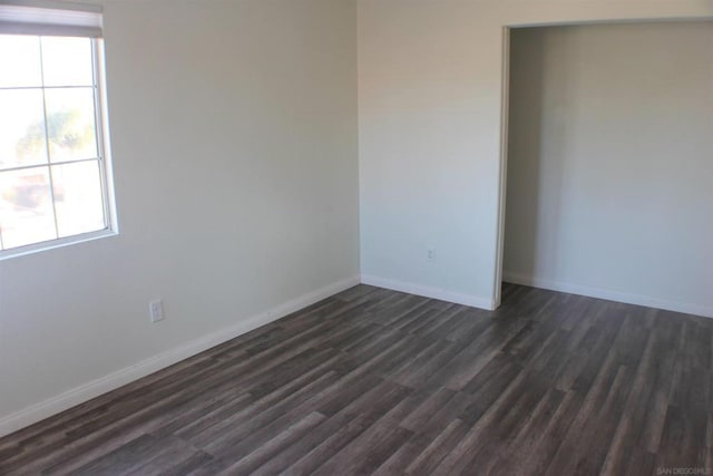 spare room featuring dark hardwood / wood-style flooring