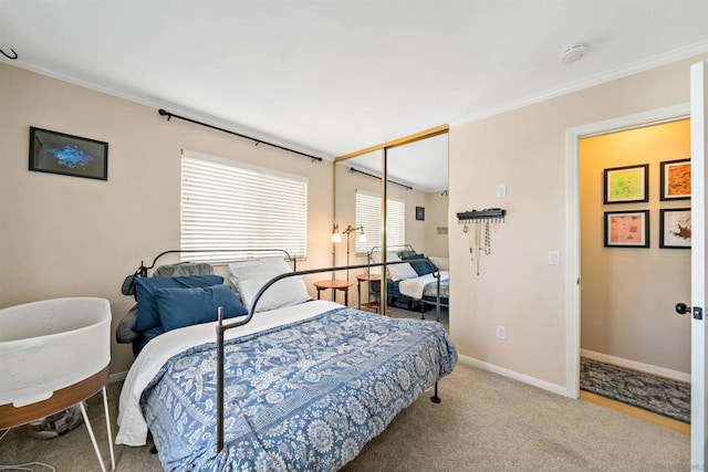 carpeted bedroom with a closet and crown molding