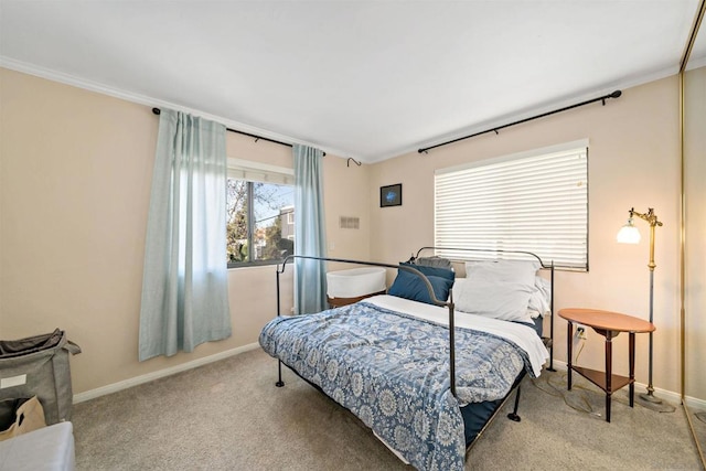 carpeted bedroom featuring crown molding