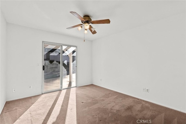 spare room with ceiling fan and light carpet