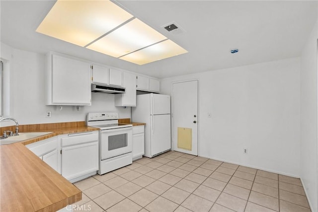 kitchen with sink, white appliances, white cabinets, and light tile patterned floors