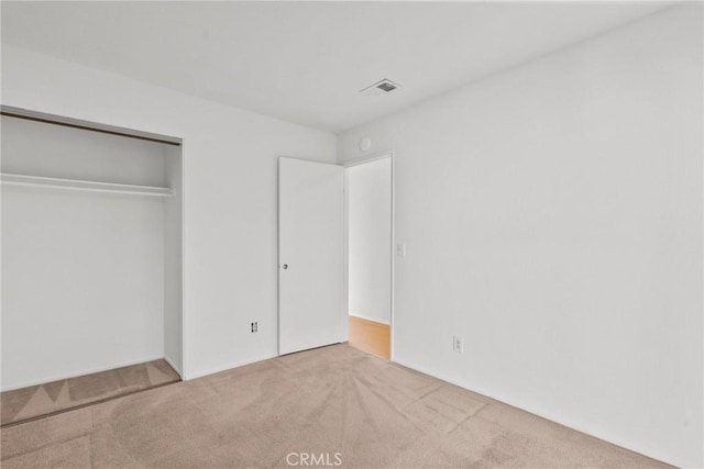 unfurnished bedroom featuring a closet and carpet