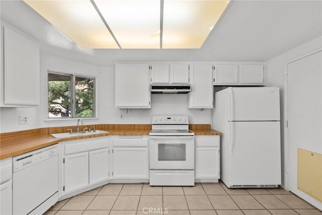 kitchen featuring light tile patterned floors, sink, white appliances, and white cabinets