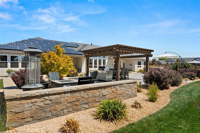 back of property featuring solar panels, a pergola, area for grilling, and a patio