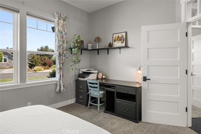 bedroom with dark carpet and multiple windows