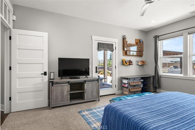 carpeted bedroom with multiple windows, ceiling fan, and access to outside