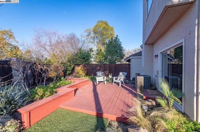 wooden deck featuring cooling unit