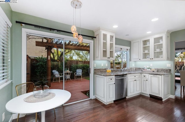 kitchen featuring pendant lighting, dishwasher, dark stone countertops, white cabinets, and dark hardwood / wood-style flooring