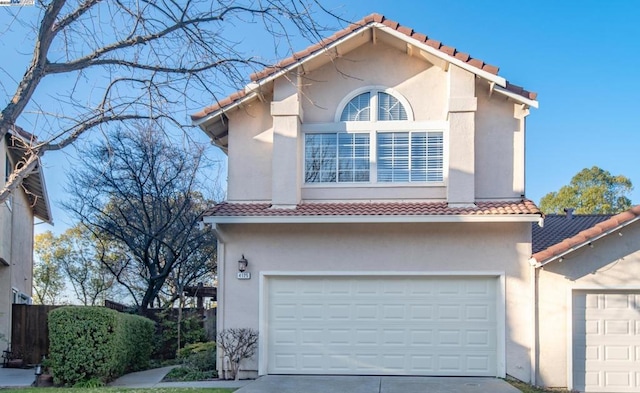 mediterranean / spanish home with a garage