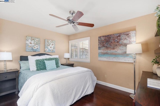 bedroom with dark hardwood / wood-style flooring and ceiling fan