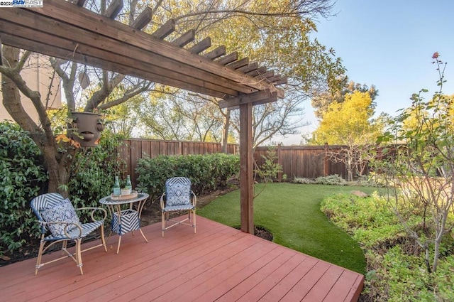 deck with a pergola and a lawn