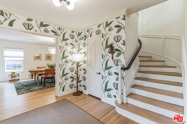 foyer featuring hardwood / wood-style flooring and a chandelier