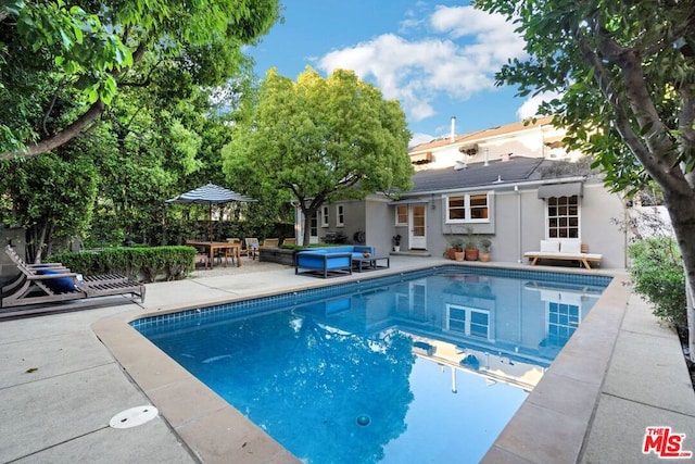 view of swimming pool with a patio area