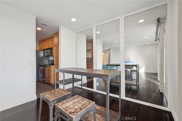 dining space featuring dark hardwood / wood-style floors