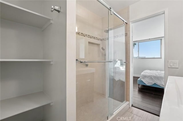 bathroom featuring hardwood / wood-style flooring and a shower with door