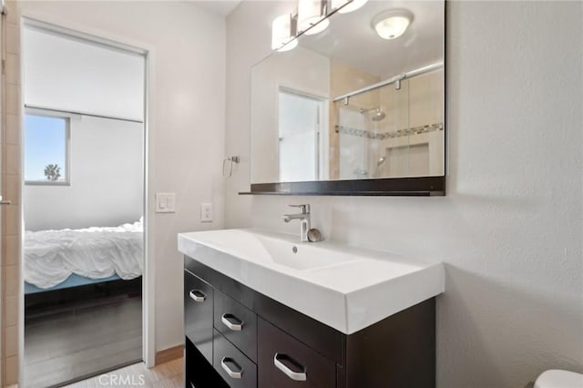 bathroom featuring vanity and a shower with shower door