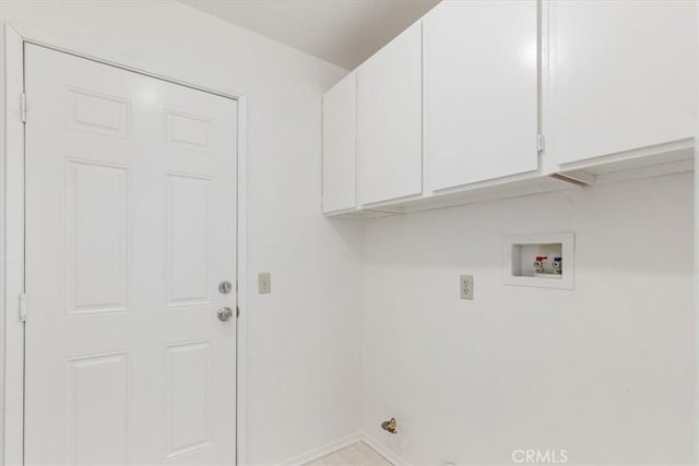 washroom with hookup for a washing machine and cabinets