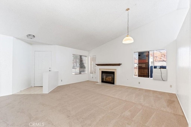 unfurnished living room featuring high vaulted ceiling, light colored carpet, and a tiled fireplace