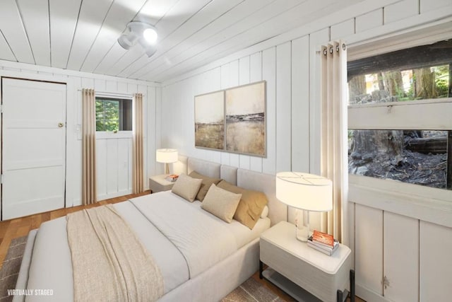 bedroom with hardwood / wood-style flooring and wooden ceiling