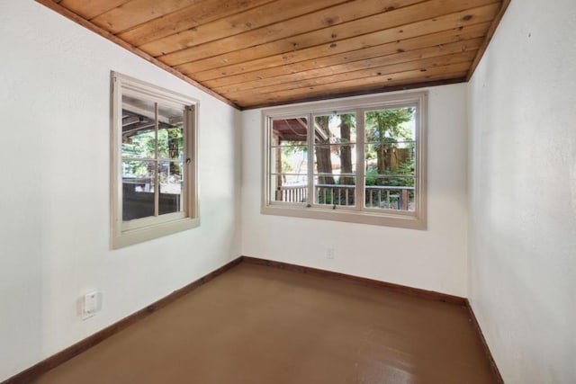 empty room with vaulted ceiling and wooden ceiling