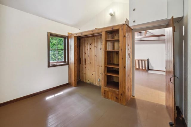 unfurnished bedroom with lofted ceiling and wood-type flooring