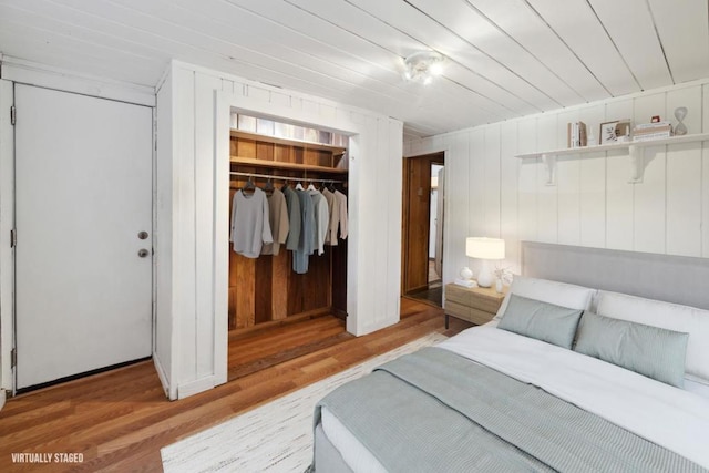 bedroom with wood-type flooring and a closet