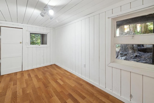 spare room featuring wood ceiling and light hardwood / wood-style flooring