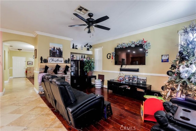 living room featuring crown molding and ceiling fan