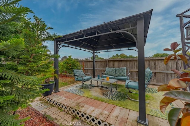 view of patio / terrace featuring a deck, a gazebo, and an outdoor hangout area